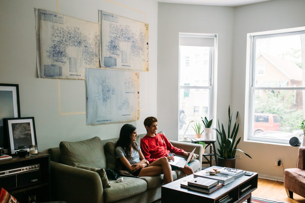 A couple in good spirits reviewing info on a laptop